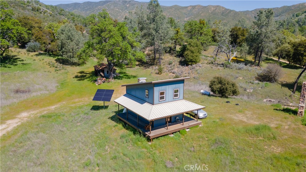 0 Av Ranch Road Greenfield, CA 93927 - Photo 22 of 26 a white house with a big yard and large tree