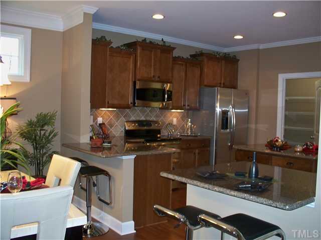 7652 Birchmoor Way, Unit LT64 Raleigh, NC 27616 - Photo 3 of 4 a kitchen with a sink appliances and cabinets