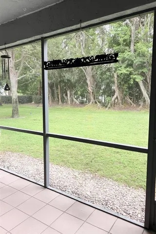 a view of a lake and a yard from a window