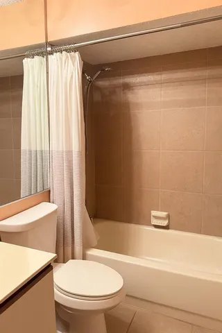 a bathroom with a toilet and a bathtub