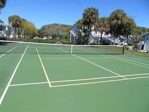 9778 Nickels Boulevard, Unit 504 Boynton Beach, FL 33436 - Photo 29 of 31 a view of an outdoor space and tennis court