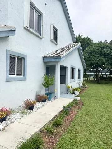 a front view of a house with a garden and porch