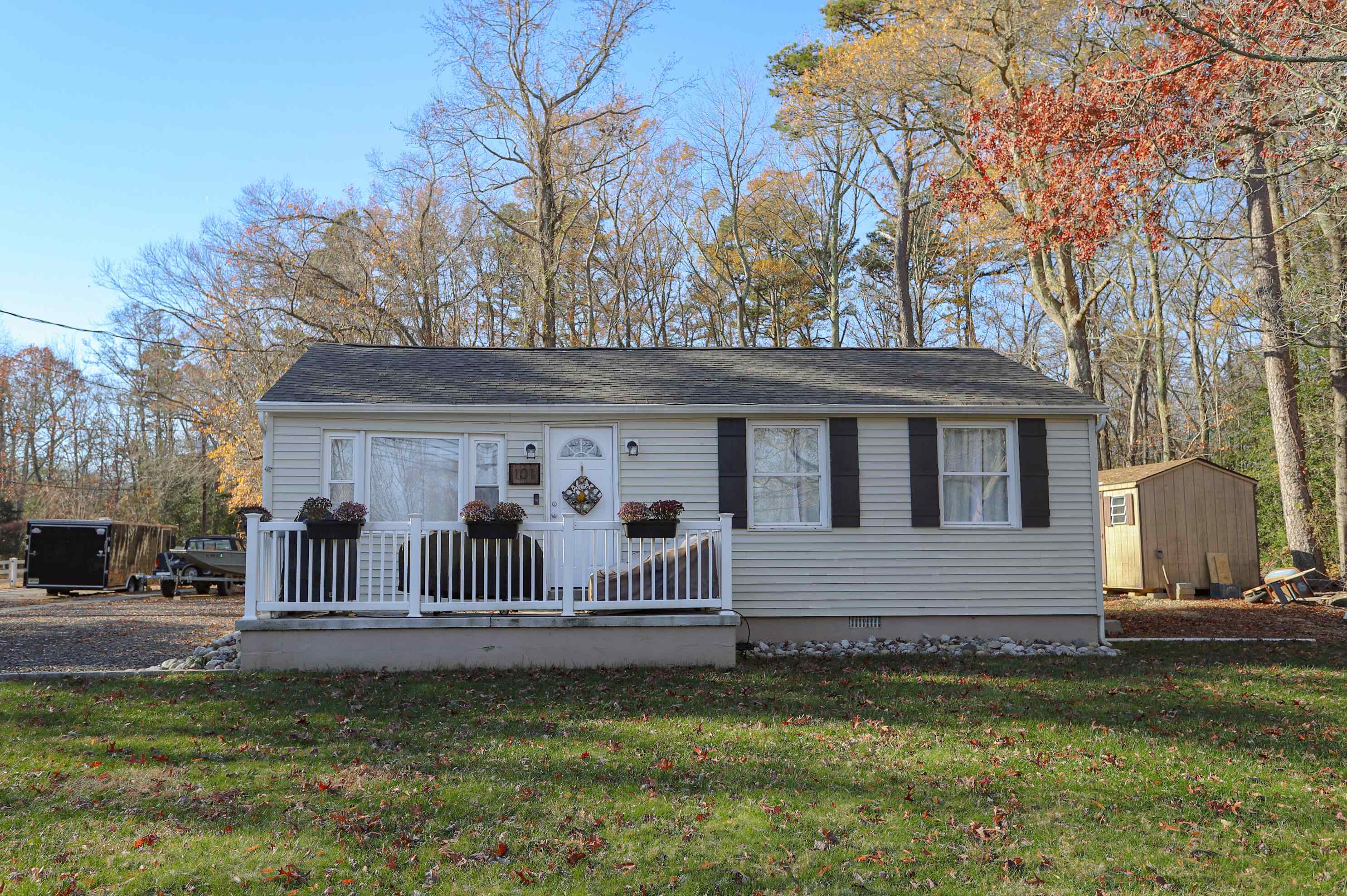 a front view of a house with a garden and deck