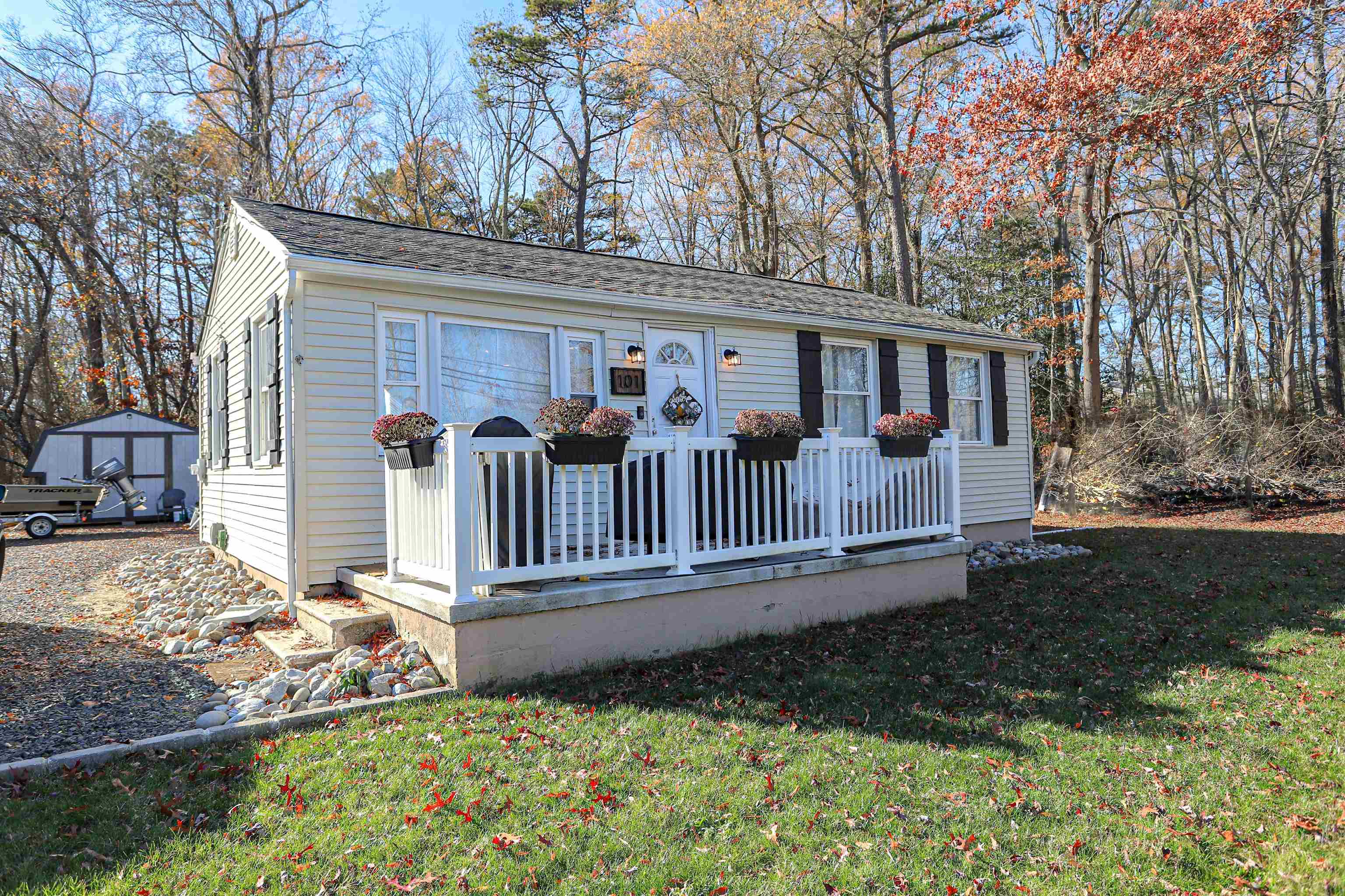 101 Sunset Road Corbin City, NJ 08270 - Photo 2 of 21 a view of a house with a yard and wooden fence
