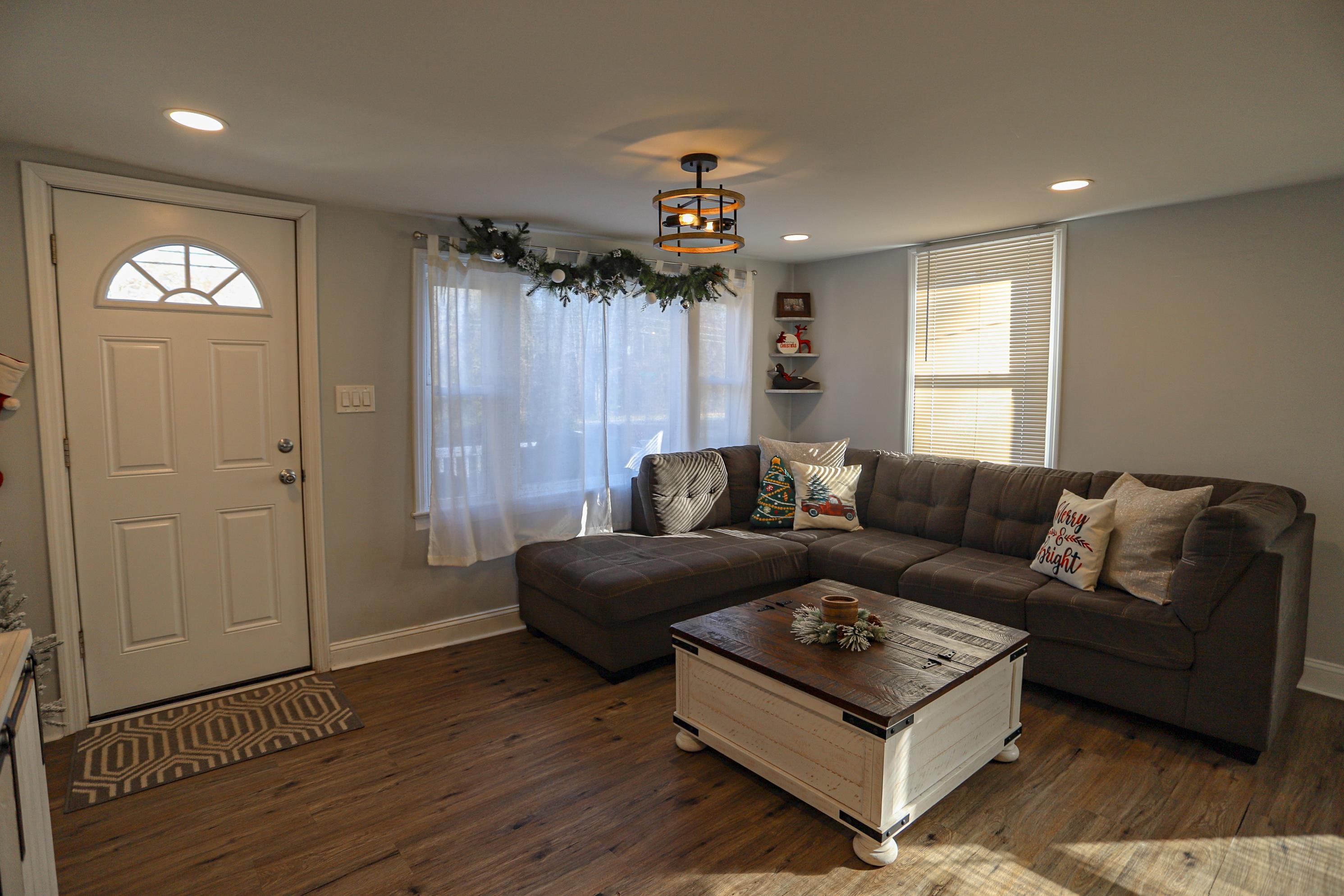 101 Sunset Road Corbin City, NJ 08270 - Photo 3 of 21 a living room with furniture and a chandelier