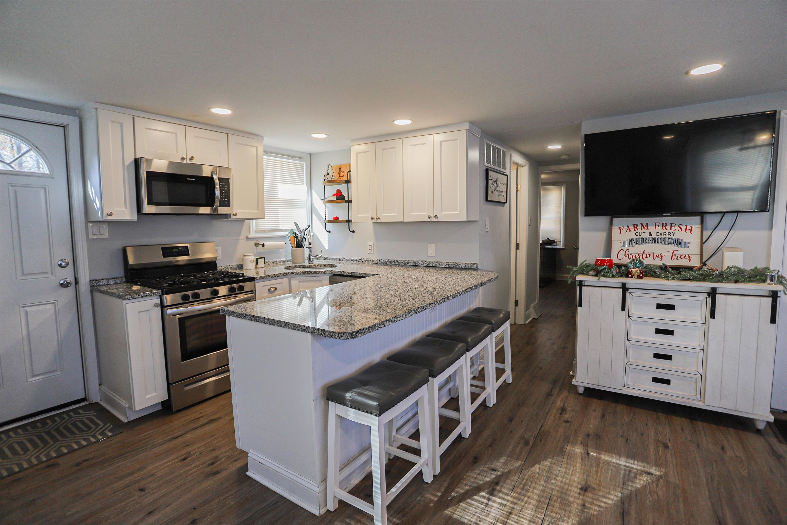 101 Sunset Road Corbin City, NJ 08270 - Photo 6 of 21 a kitchen with stainless steel appliances kitchen island granite countertop a stove and a sink