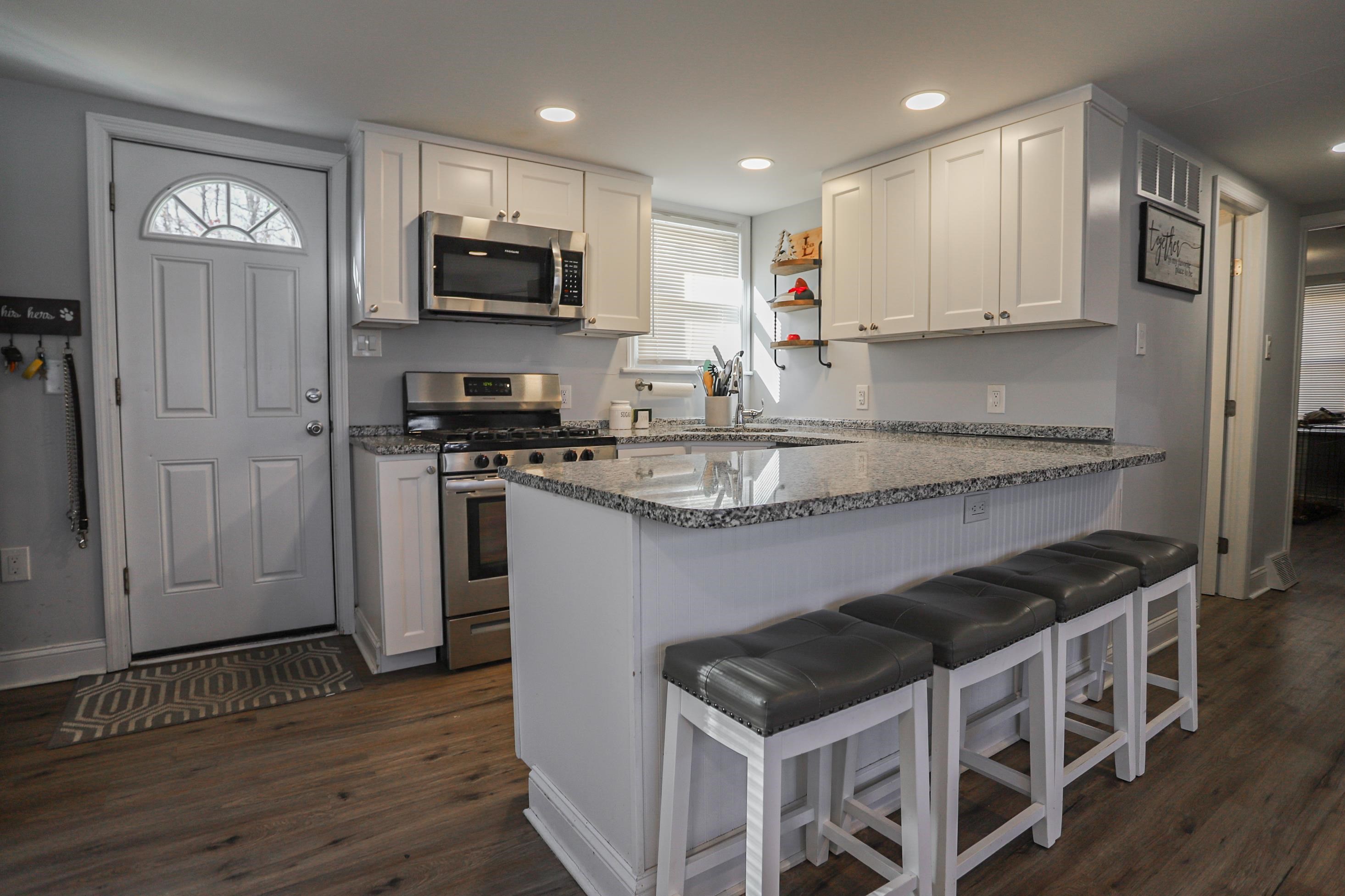 101 Sunset Road Corbin City, NJ 08270 - Photo 9 of 21 a kitchen with granite countertop stainless steel appliances and wooden cabinets
