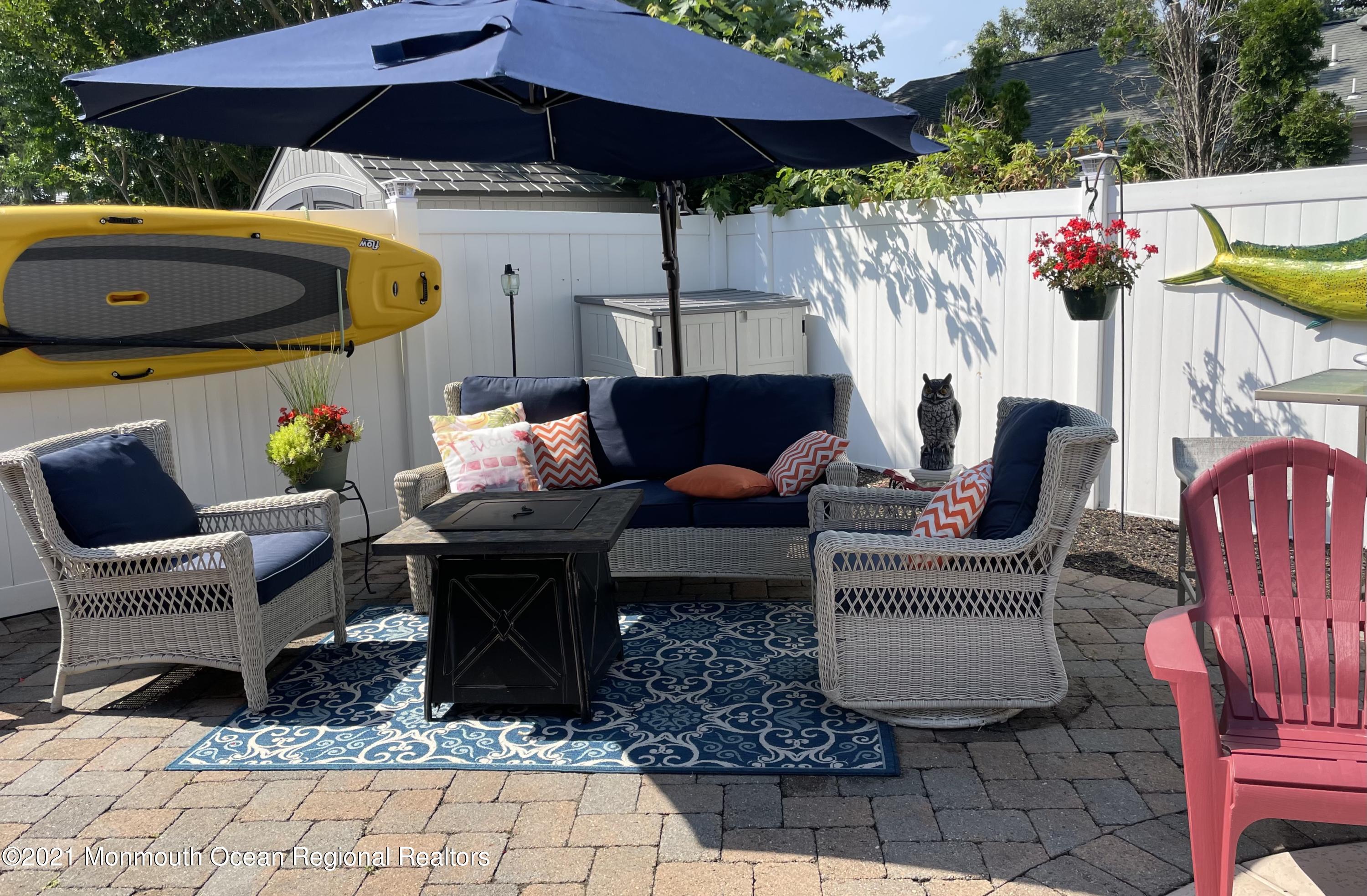 2311 Pineneedle Road Point Pleasant, NJ 08742 - Photo 5 of 5 a patio with tables and chairs