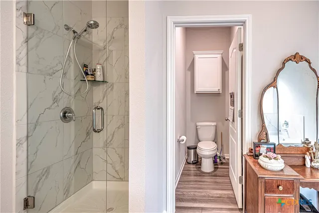a bathroom with a double vanity sink toilet and shower