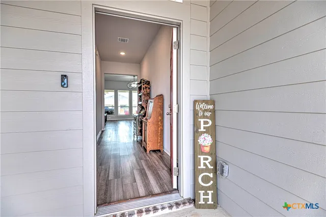 a view of hallway with wooden floor