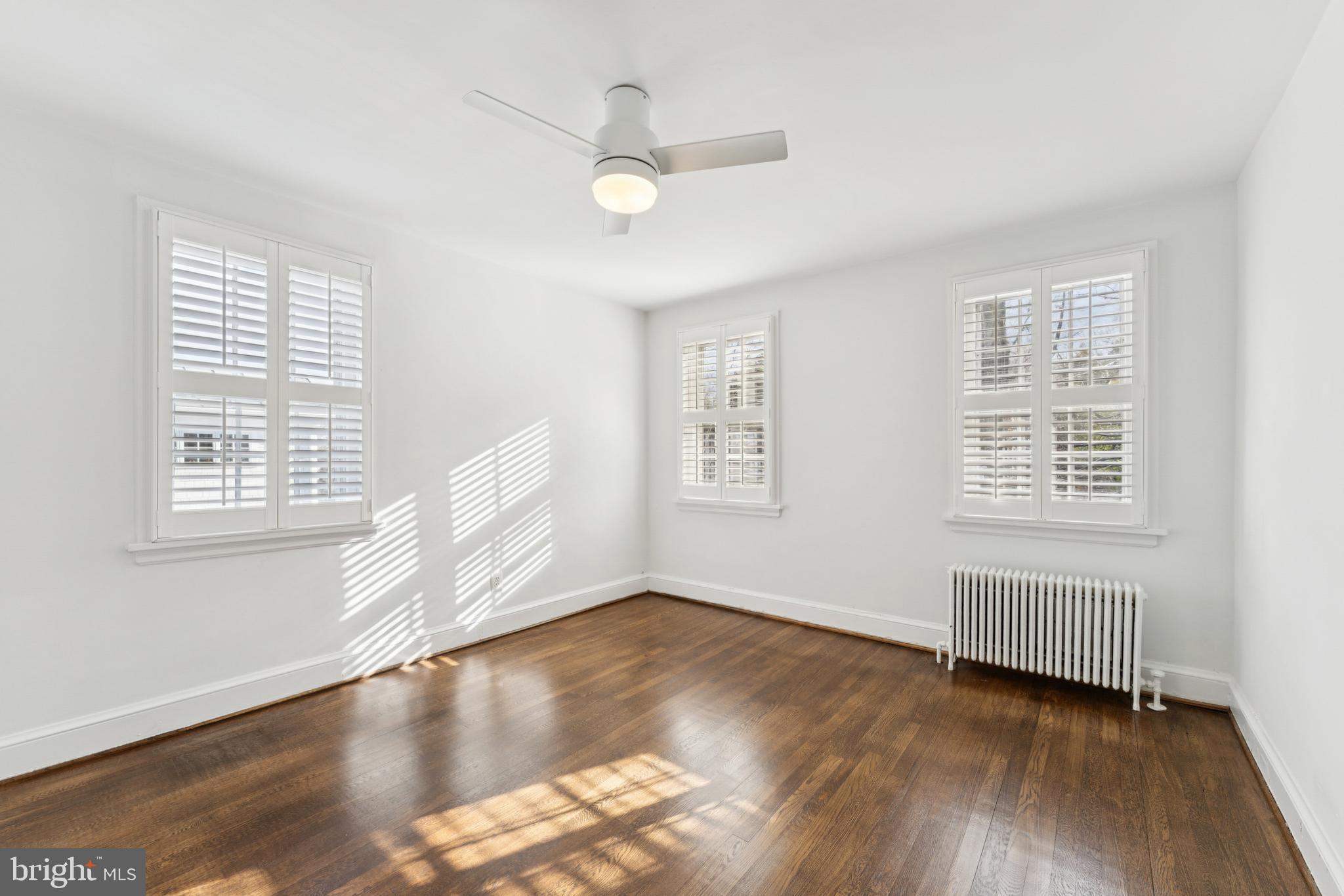 3515 Taylor Street Chevy Chase, MD 20815 - Photo 19 of 40 a view of an empty room with wooden floor and a window