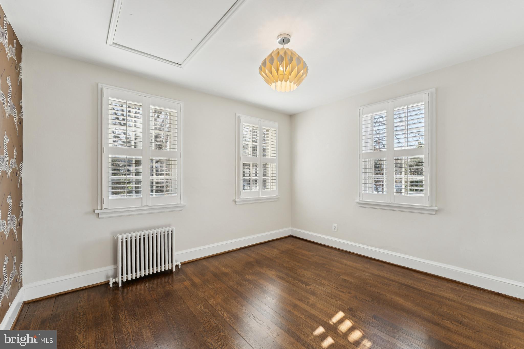 3515 Taylor Street Chevy Chase, MD 20815 - Photo 22 of 40 a view of an empty room with wooden floor and a window