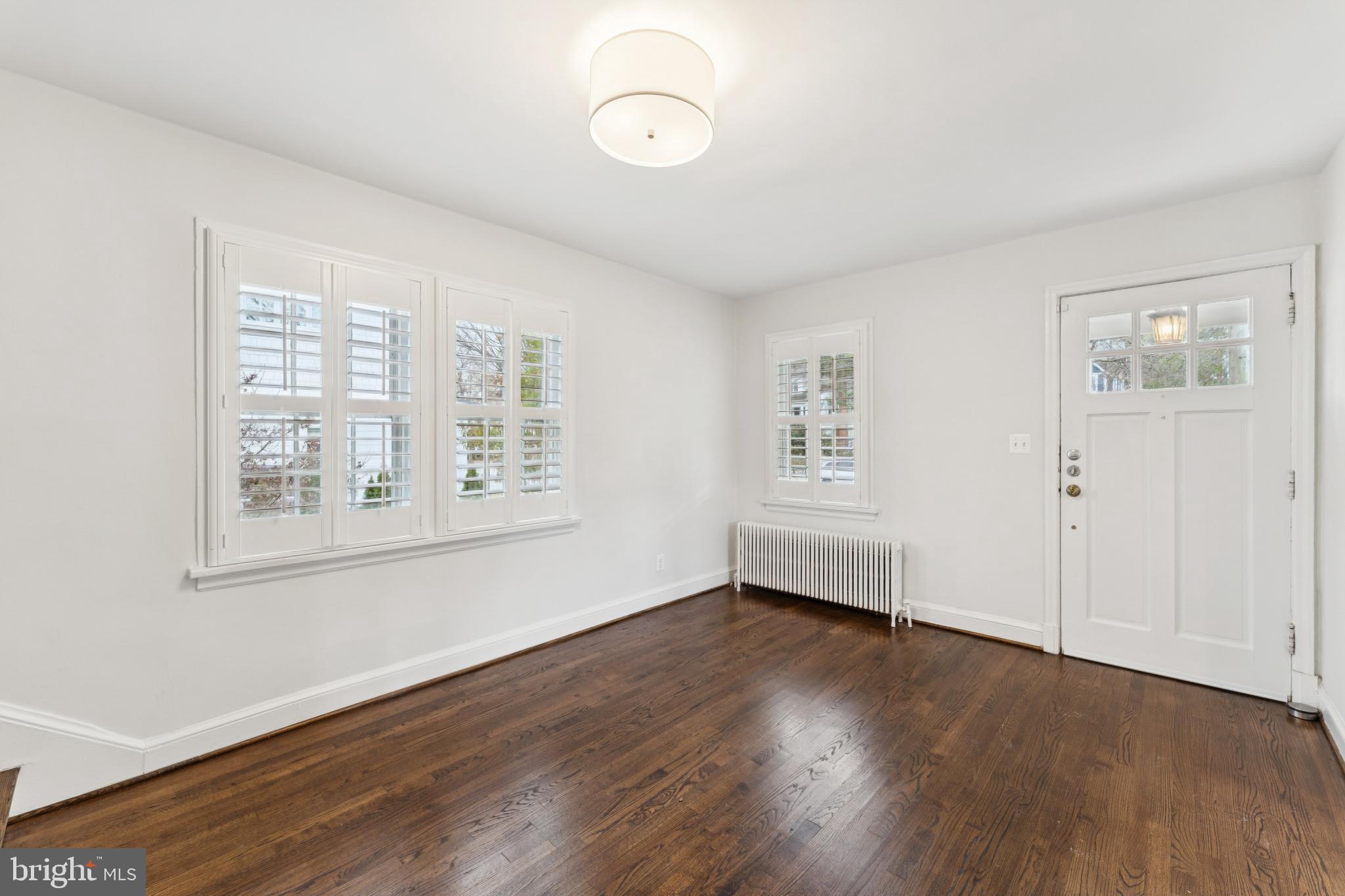 3515 Taylor Street Chevy Chase, MD 20815 - Photo 6 of 40 an empty room with wooden floor and windows