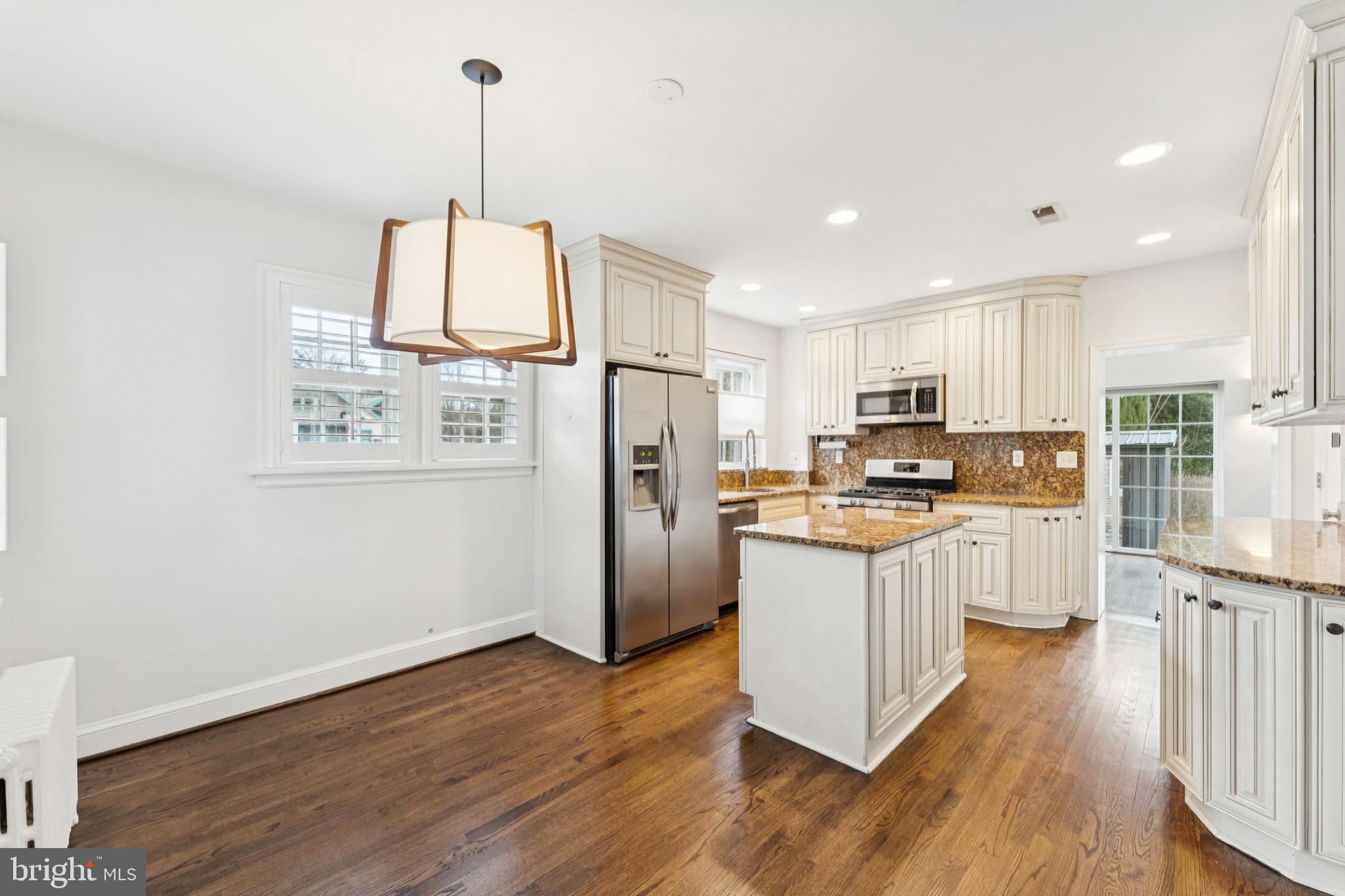 3515 Taylor Street Chevy Chase, MD 20815 - Photo 7 of 40 a kitchen with stainless steel appliances granite countertop a refrigerator a stove top oven a sink and a center island