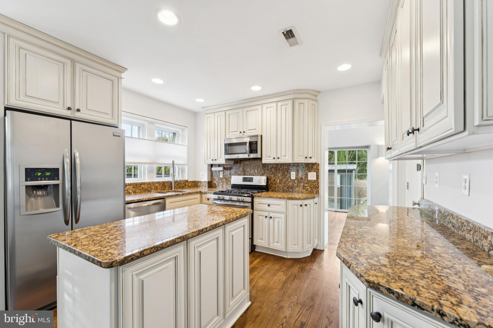 3515 Taylor Street Chevy Chase, MD 20815 - Photo 9 of 40 a kitchen with stainless steel appliances granite countertop a sink stove microwave and refrigerator