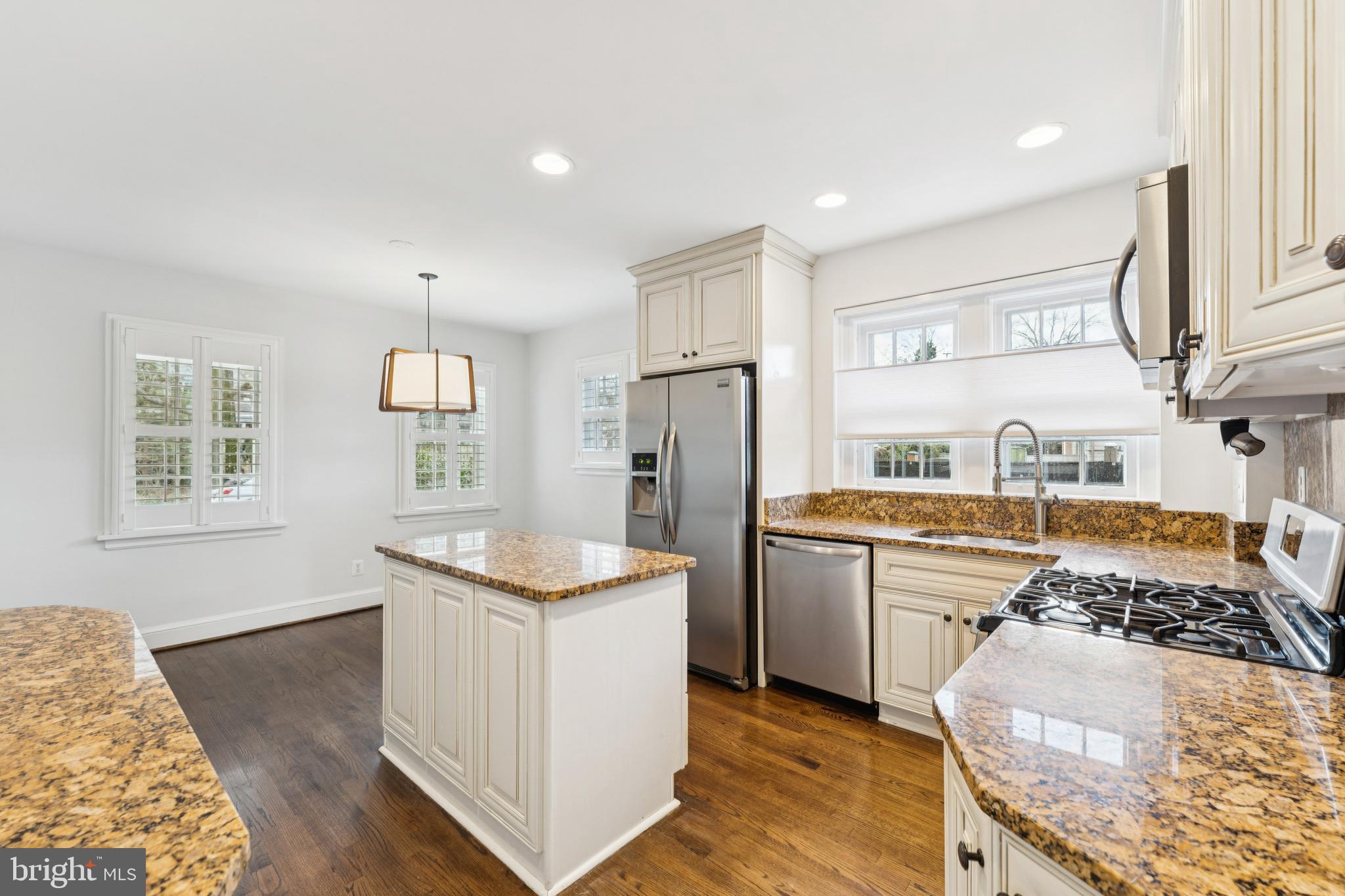 3515 Taylor Street Chevy Chase, MD 20815 - Photo 10 of 40 a kitchen with stainless steel appliances granite countertop a sink stove and refrigerator