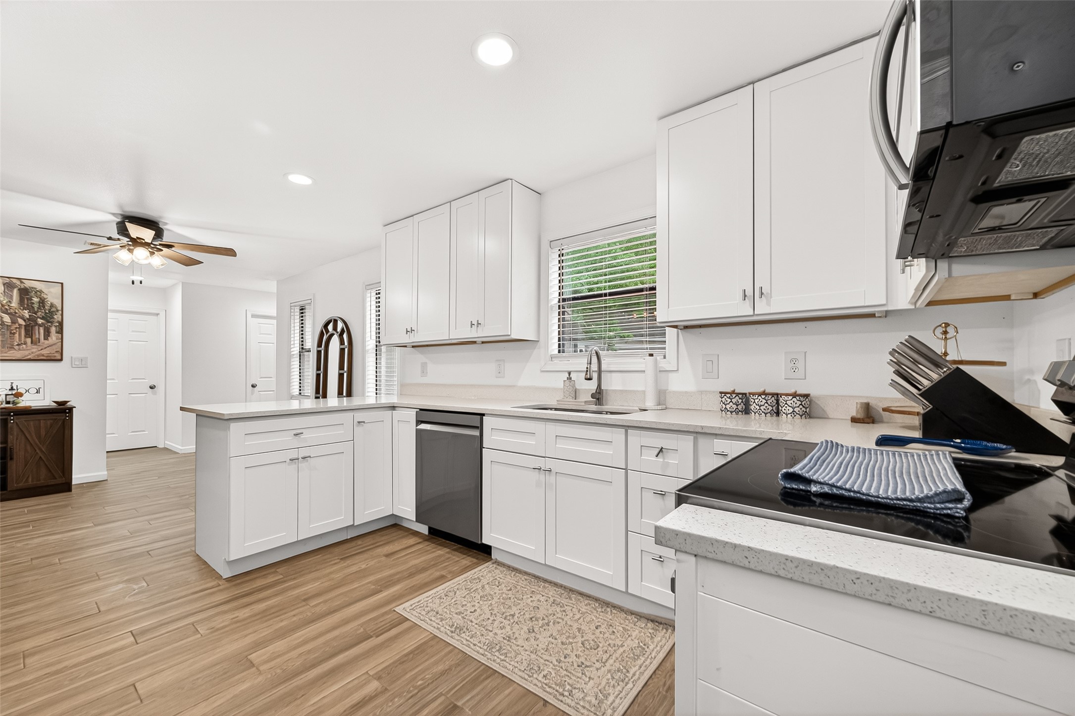 548 Brandon Road Conroe, TX 77302 - Photo 11 of 37 Modern white chef's kitchen features stylish cabinetry and hardware, stainless steel appliances, and a clean neutral design