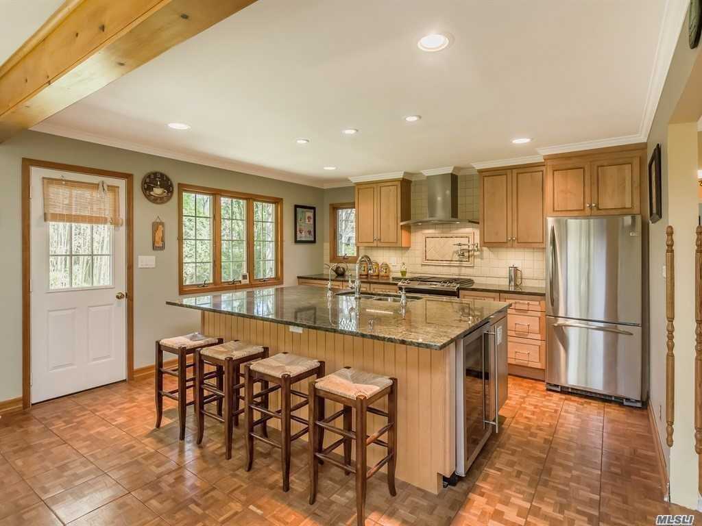 a kitchen with stainless steel appliances granite countertop a stove and refrigerator