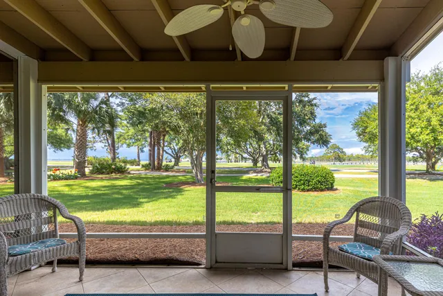 a living room with hardwood floor and balcony