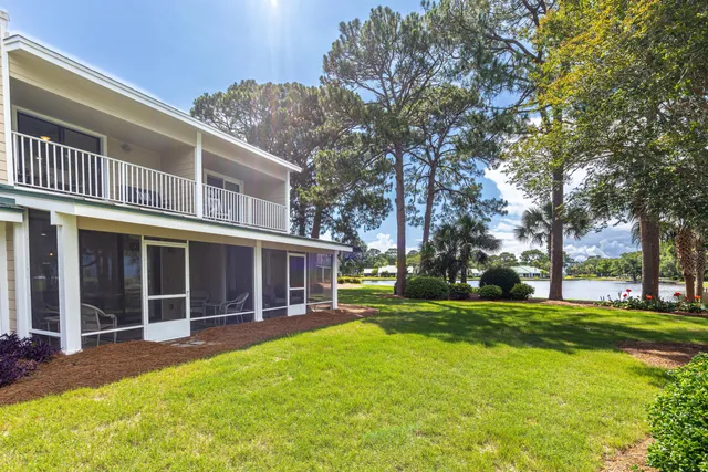 a view of a house with a yard and tree s