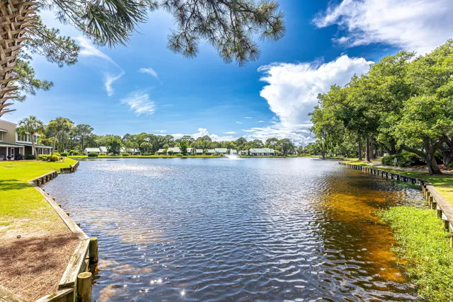 a view of a lake with houses in the back