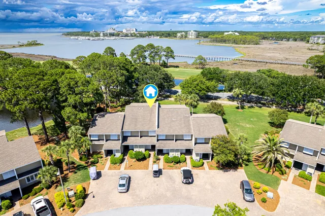 an aerial view of a house with outdoor space and lake view