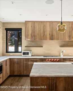 a dining room with furniture and a large window