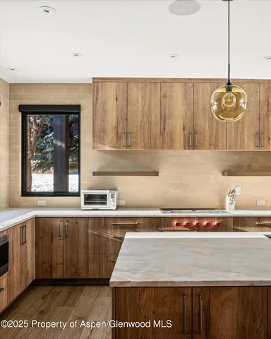a dining room with furniture and a large window