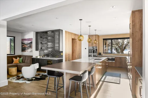 a kitchen with granite countertop a sink stove and refrigerator