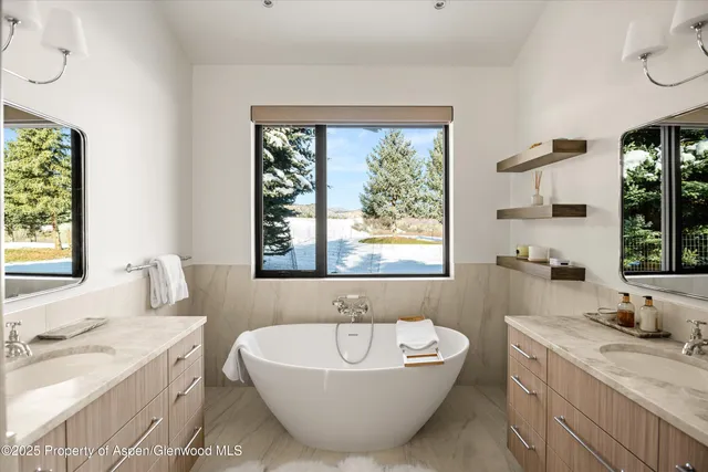 a spacious bathroom with a bathtub and sink
