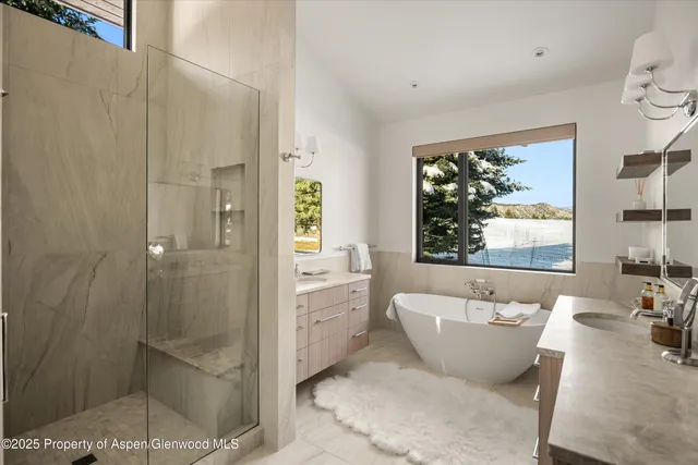 a view of walk in closet with clothes