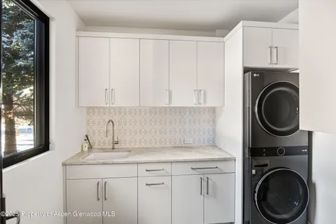 a patio with yard glass top table and chairs