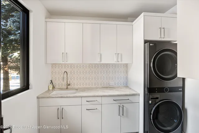 a patio with yard glass top table and chairs