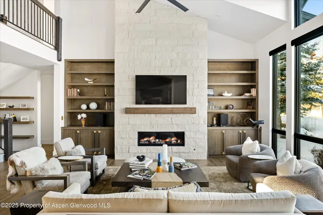 a living room with furniture a fireplace and a flat screen tv