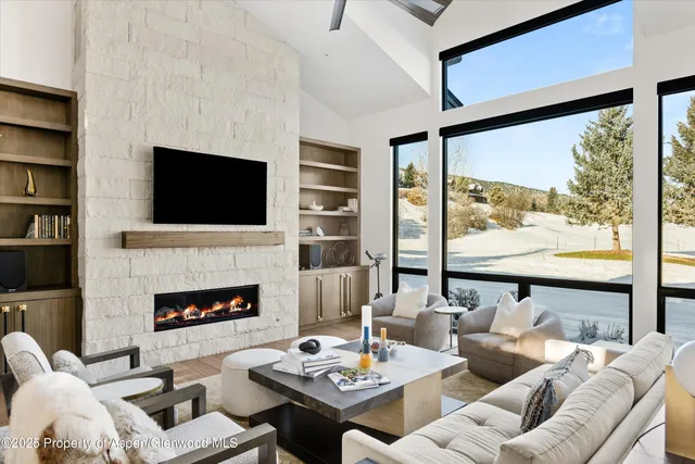 a living room with furniture fireplace and a flat screen tv