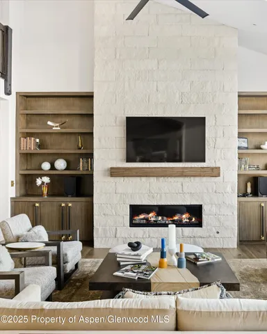 a living room with furniture and a fireplace