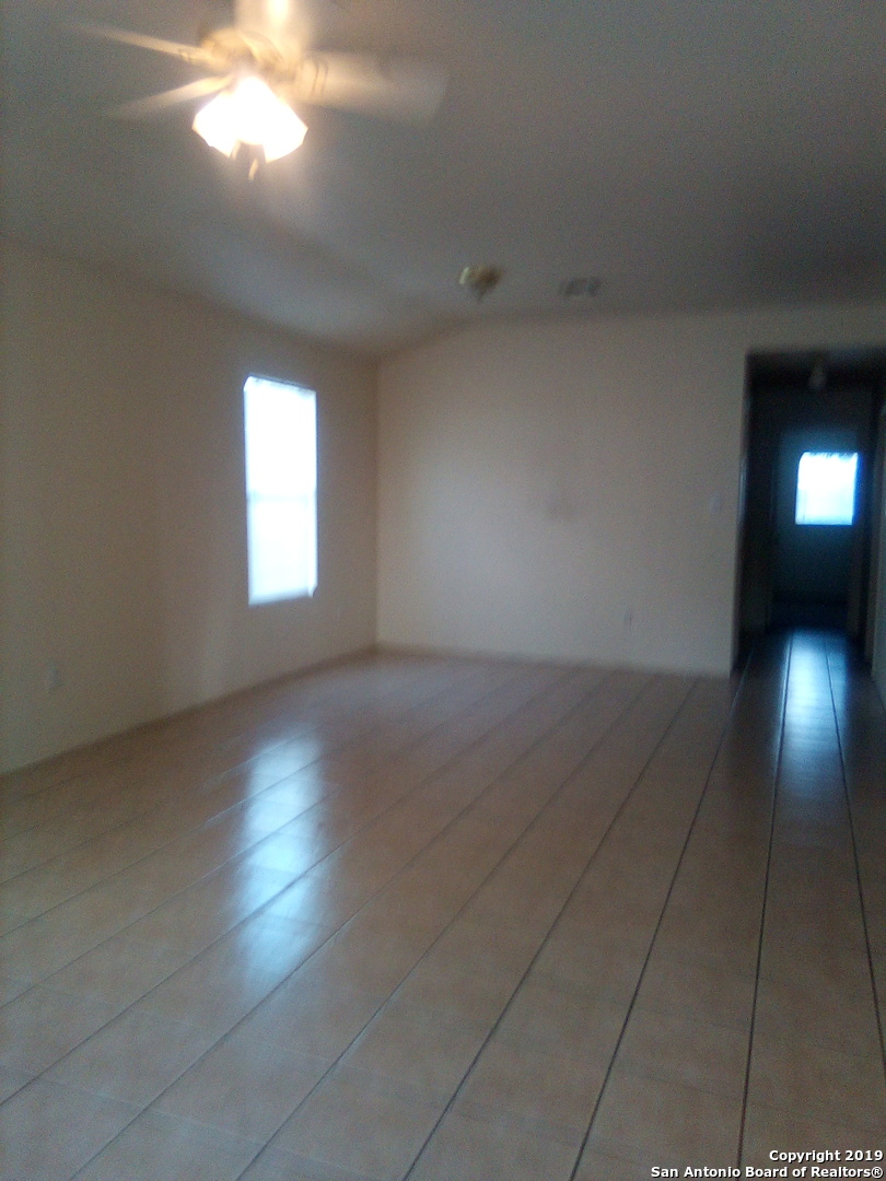 11206 Center Point Road San Antonio, TX 78233 - Photo 2 of 5 an empty room with a empty space and windows