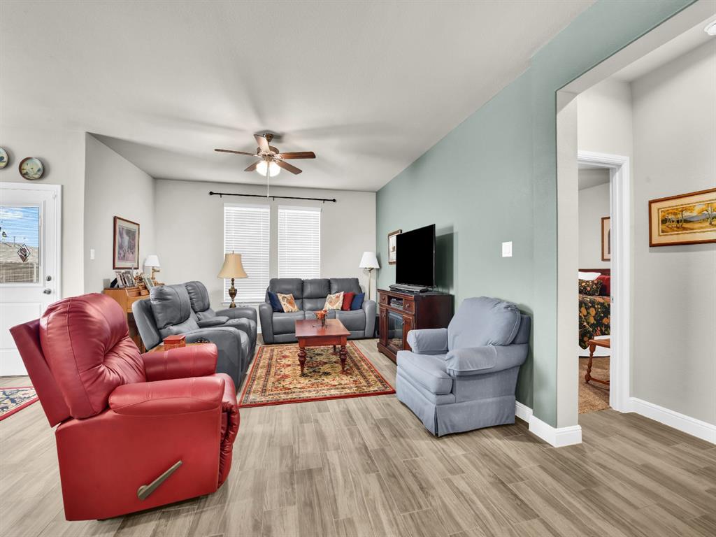2364 Waggoner Rnch Drive Weatherford, TX 76087 - Photo 16 of 30 a living room with furniture a flat screen tv and a large window