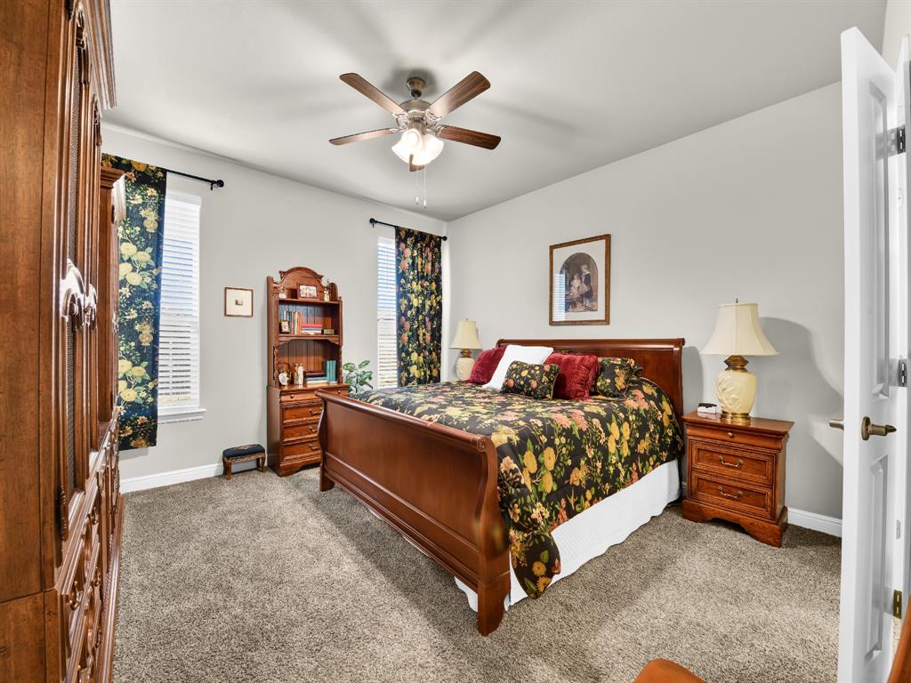 2364 Waggoner Rnch Drive Weatherford, TX 76087 - Photo 19 of 30 a bed sitting in a bedroom next to a window and a chandelier