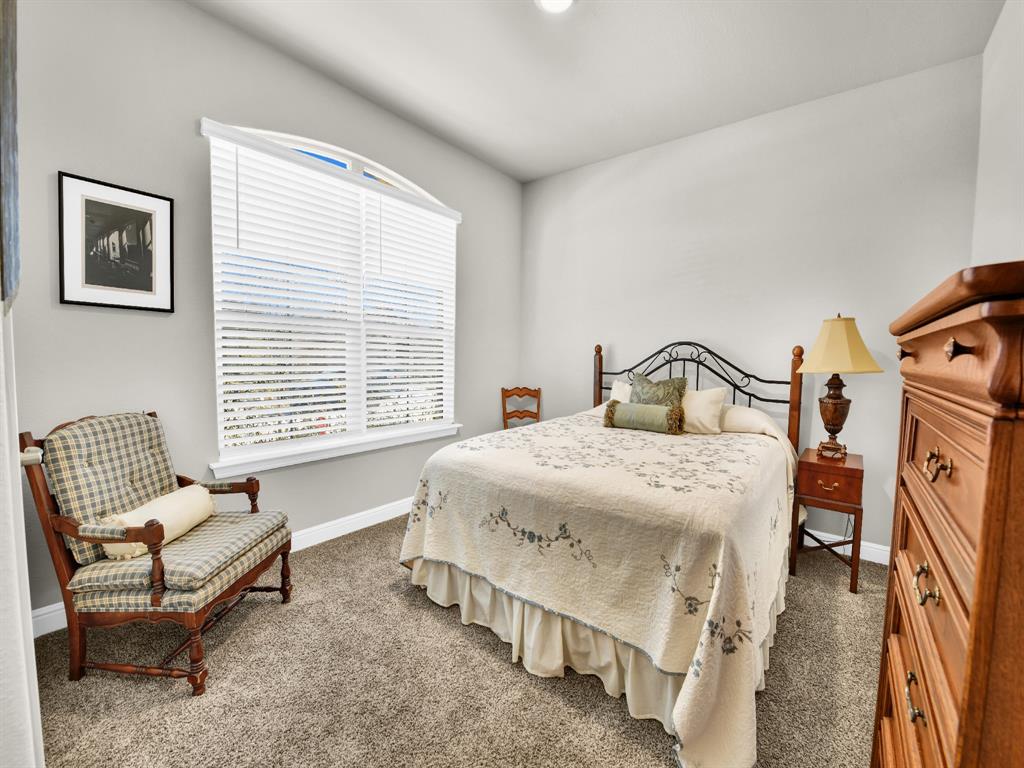 2364 Waggoner Rnch Drive Weatherford, TX 76087 - Photo 23 of 30 a bedroom with a bed chair and window