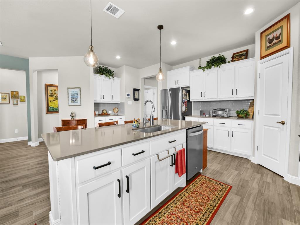 2364 Waggoner Rnch Drive Weatherford, TX 76087 - Photo 8 of 30 a kitchen with granite countertop white cabinets and white appliances