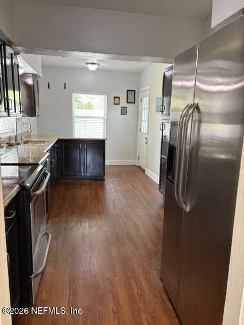 2415 Brownwood Road Jacksonville, FL 32207 - Photo 5 of 11 a kitchen with stainless steel appliances granite countertop a refrigerator a sink and a stove