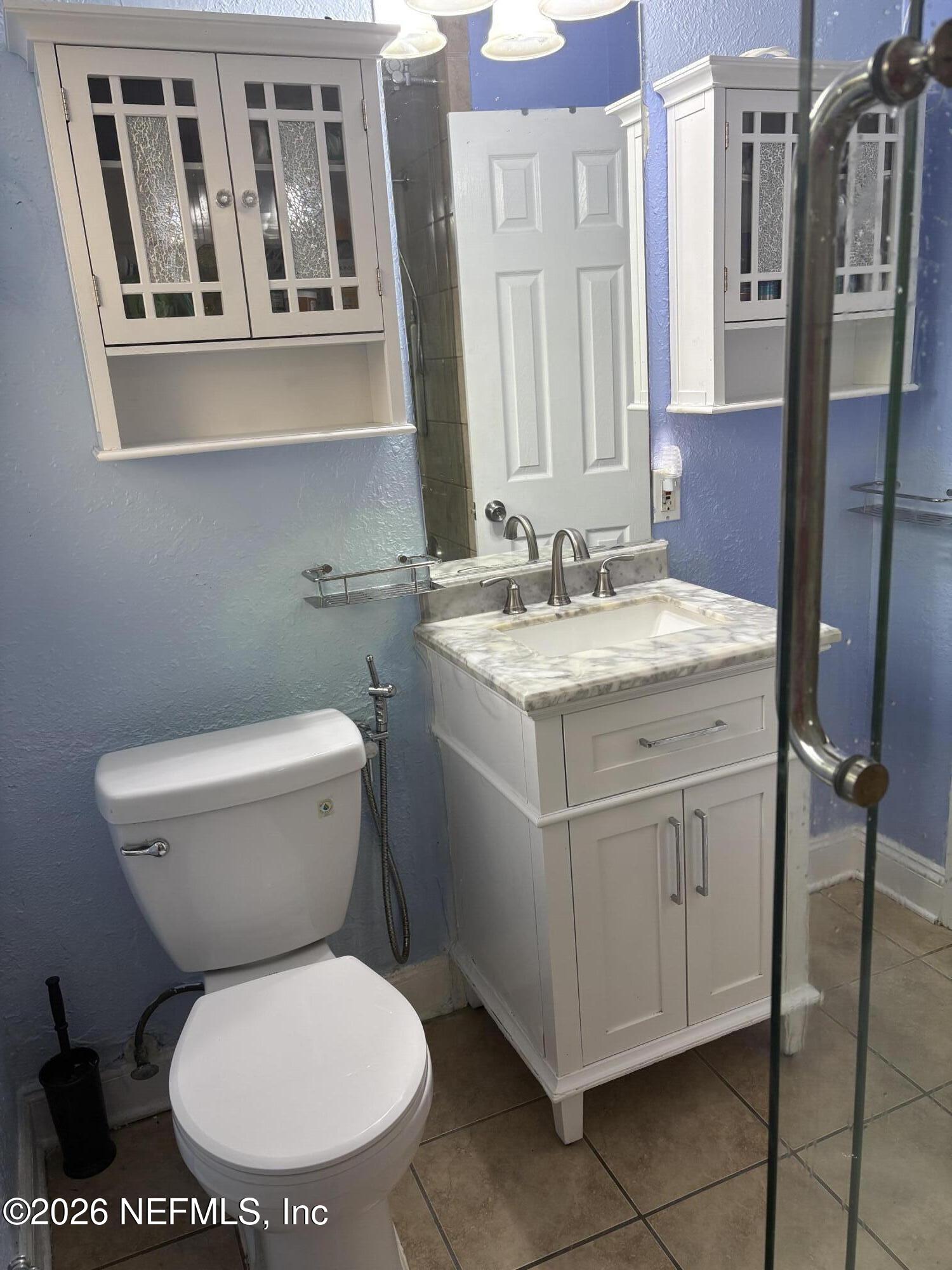 2415 Brownwood Road Jacksonville, FL 32207 - Photo 8 of 11 a bathroom with a toilet sink and a mirror