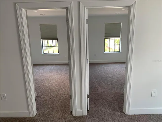 a bathroom with a sink and two mirror