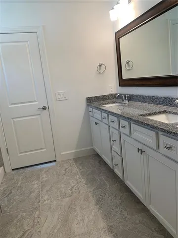 a living room with patio furniture and a floor to ceiling window