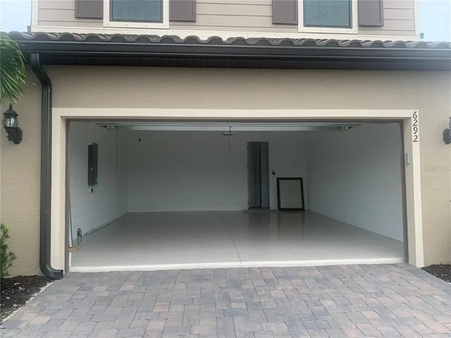 a view of a patio with a table and chairs under an umbrella
