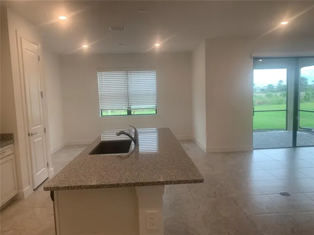 a kitchen with stainless steel appliances a stove top oven a sink and a refrigerator