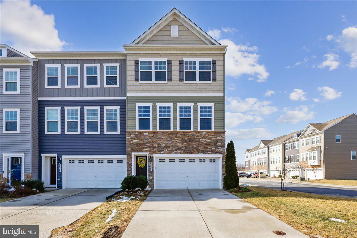 6501 Britannic Place Frederick, MD 21703 - Photo 1 of 64 a front view of a building with a garden