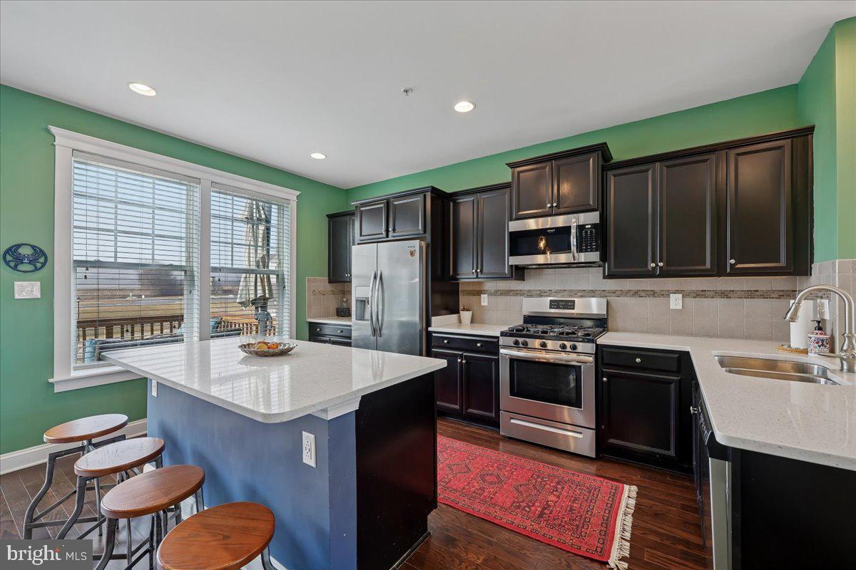 6501 Britannic Place Frederick, MD 21703 - Photo 17 of 64 a kitchen with stainless steel appliances granite countertop a sink stove and refrigerator