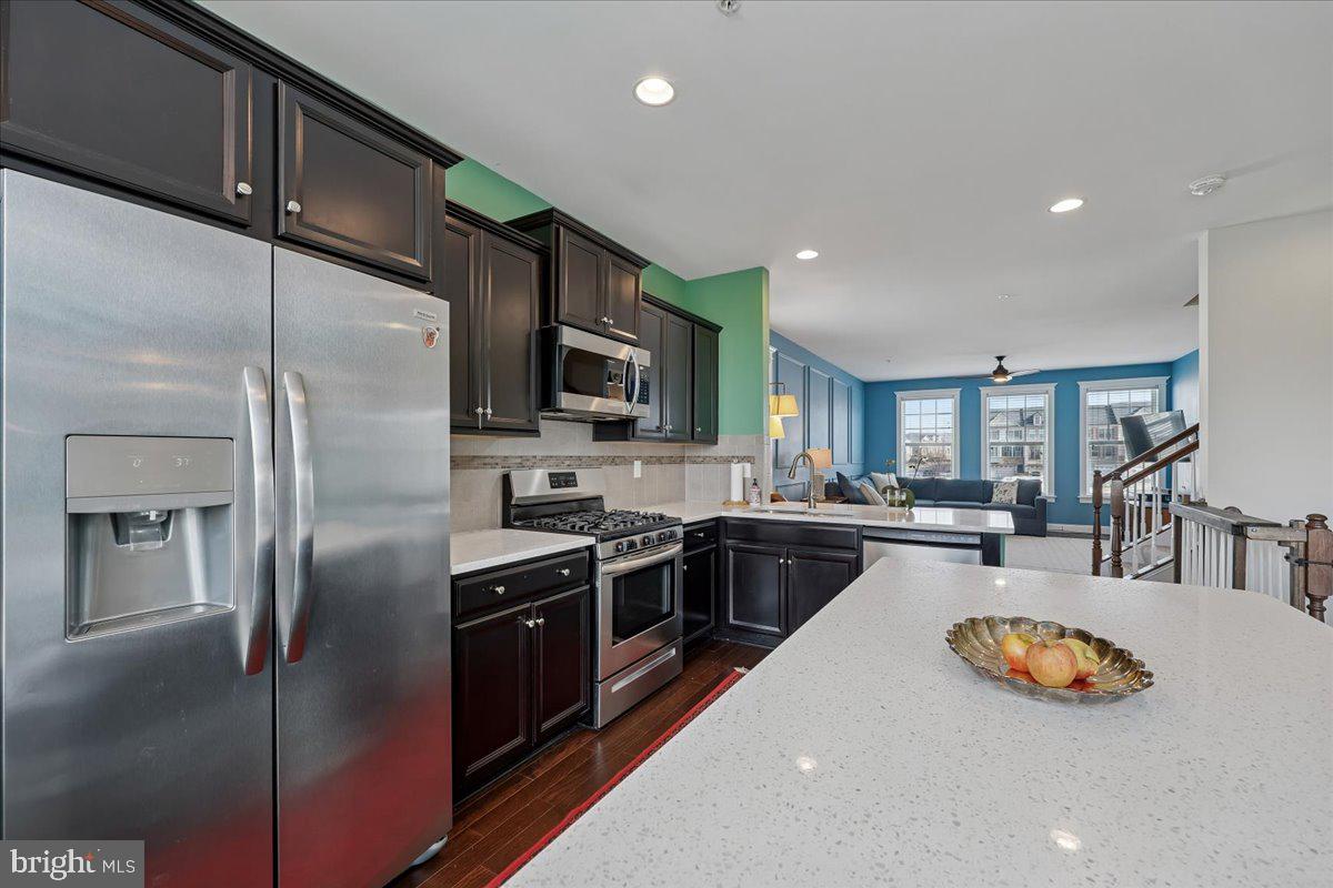 6501 Britannic Place Frederick, MD 21703 - Photo 19 of 64 a kitchen with stainless steel appliances granite countertop a sink a stove and a refrigerator